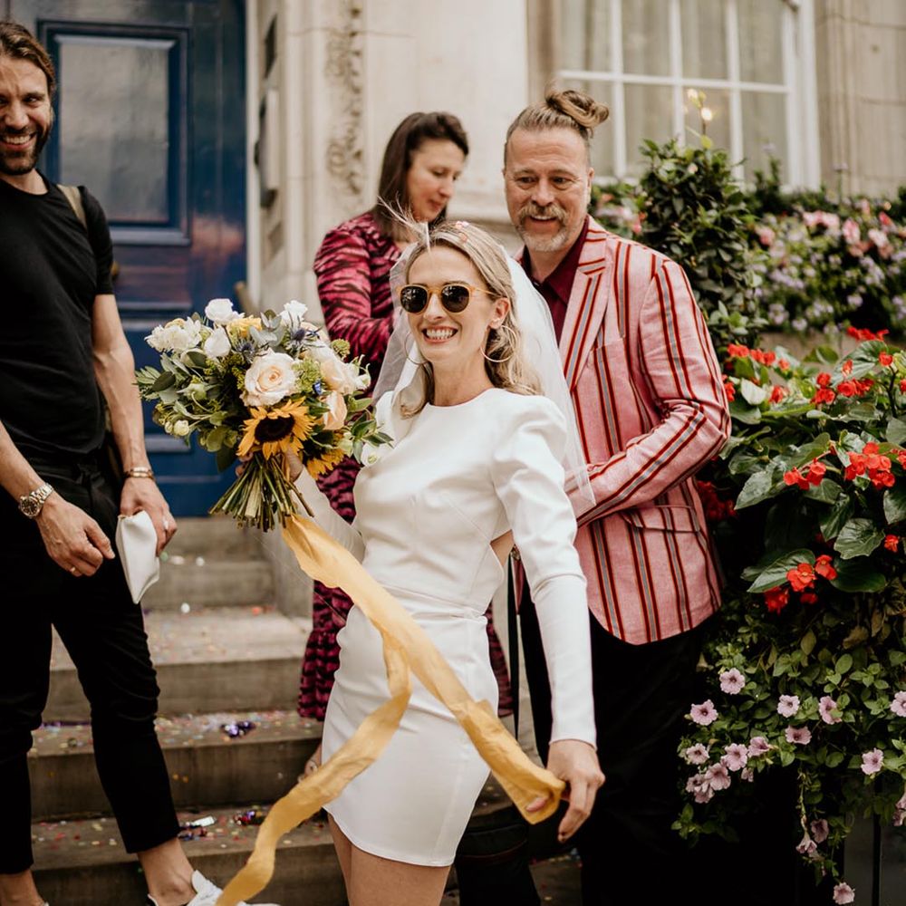 bride wearing short wedding dress and pink sunglasses