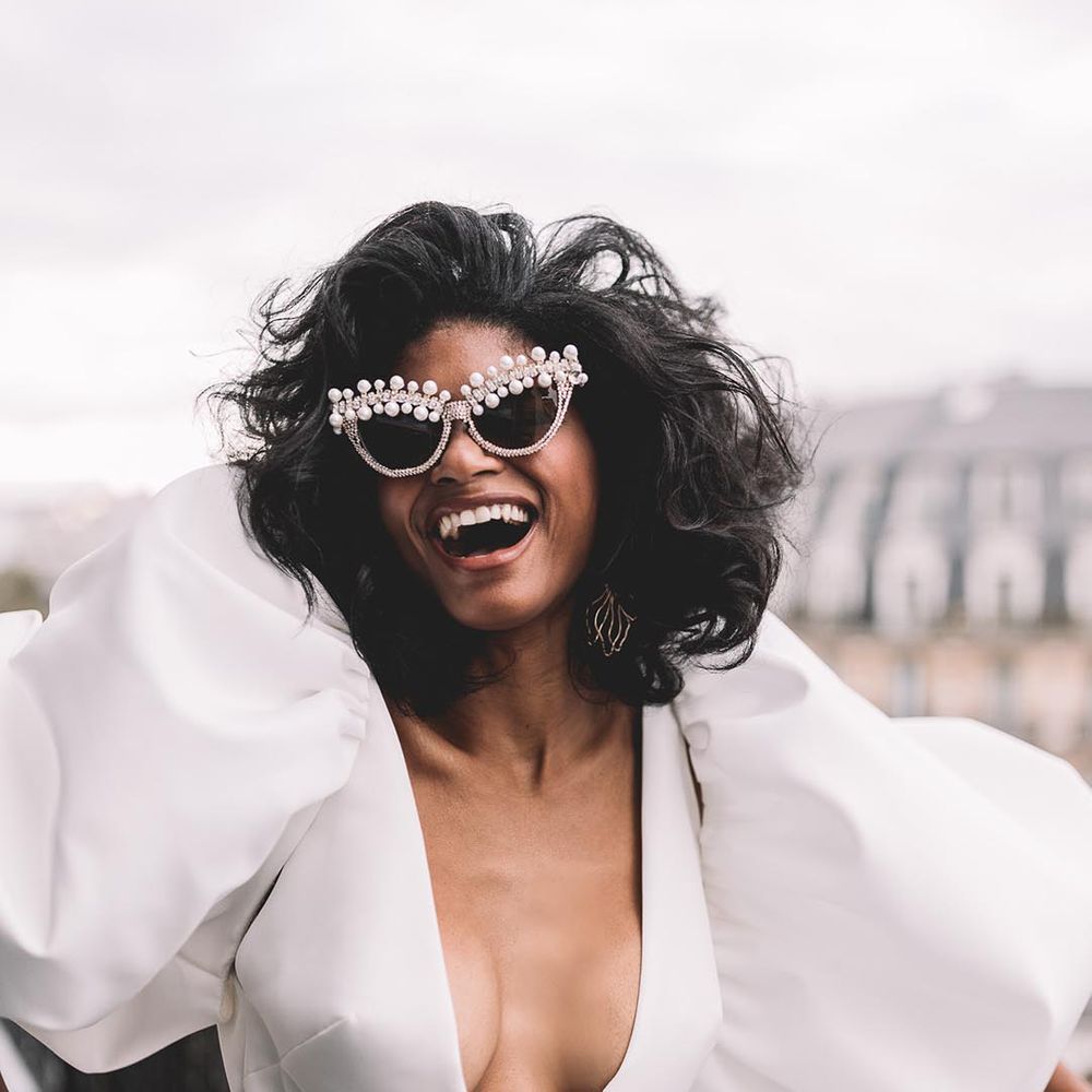 bride wearing pearl embellished white wedding sunglasses