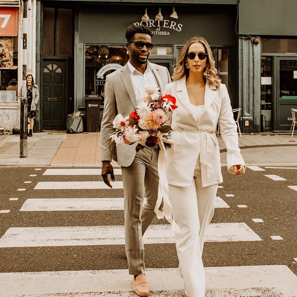 couple wearing wedding sunglasses for chic city wedding