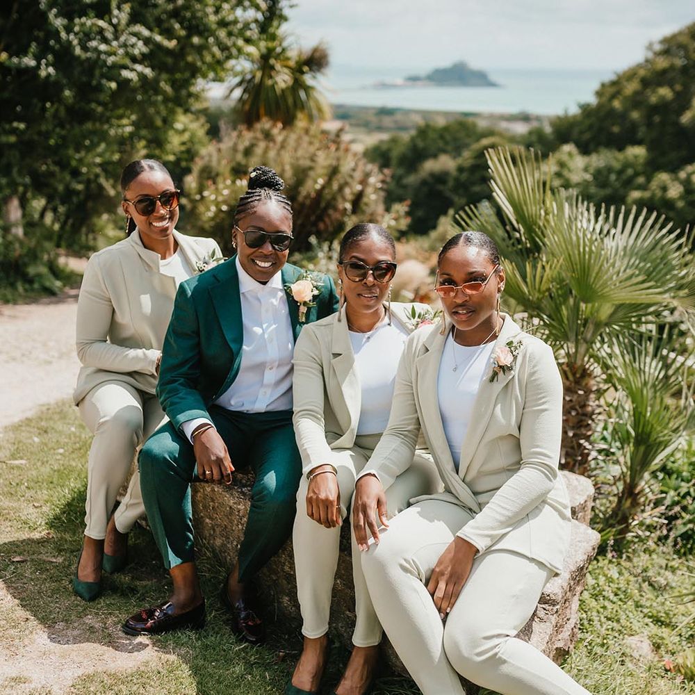 bridal party wearing wedding sunglasses and green suits