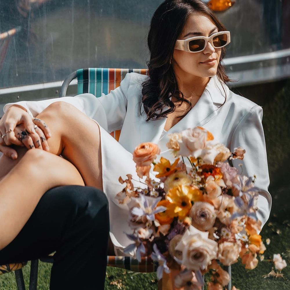 bride wearing short wedding dress and statement sunglasses