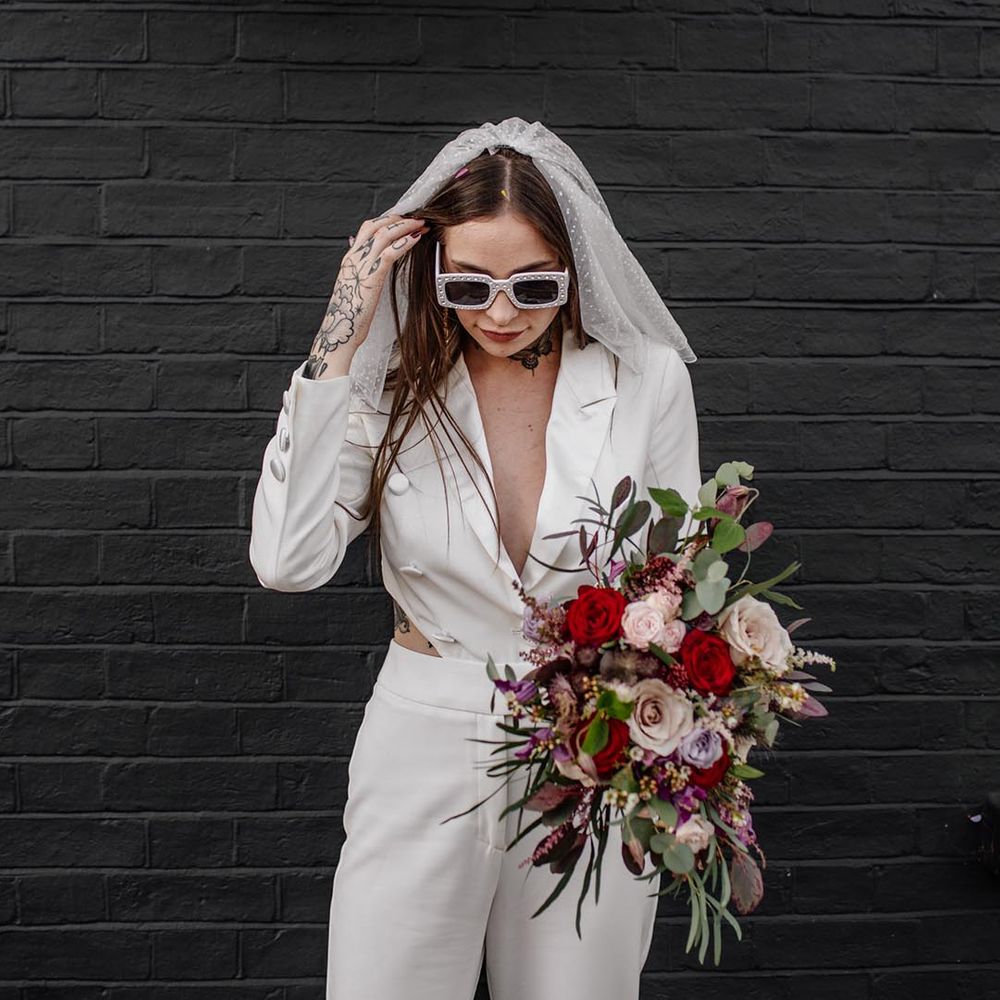 bride wearing statement white wedding sunglasses