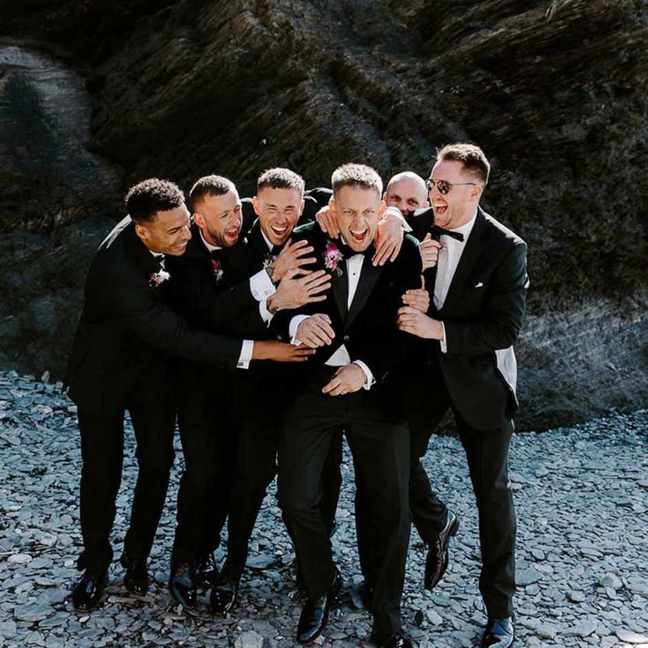 groom and groomsmen wearing black tuxedos 