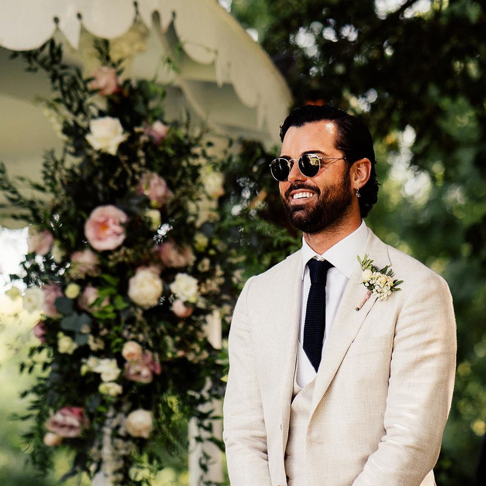 groom wearing wedding sunglasses and beige three-piece summer suit