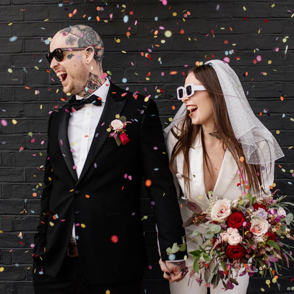 couple wearing wedding sunglasses for confetti moment 