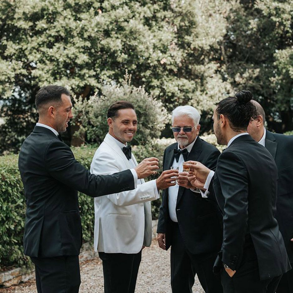 Group of groomsmen cheersing drinks stag do activity 