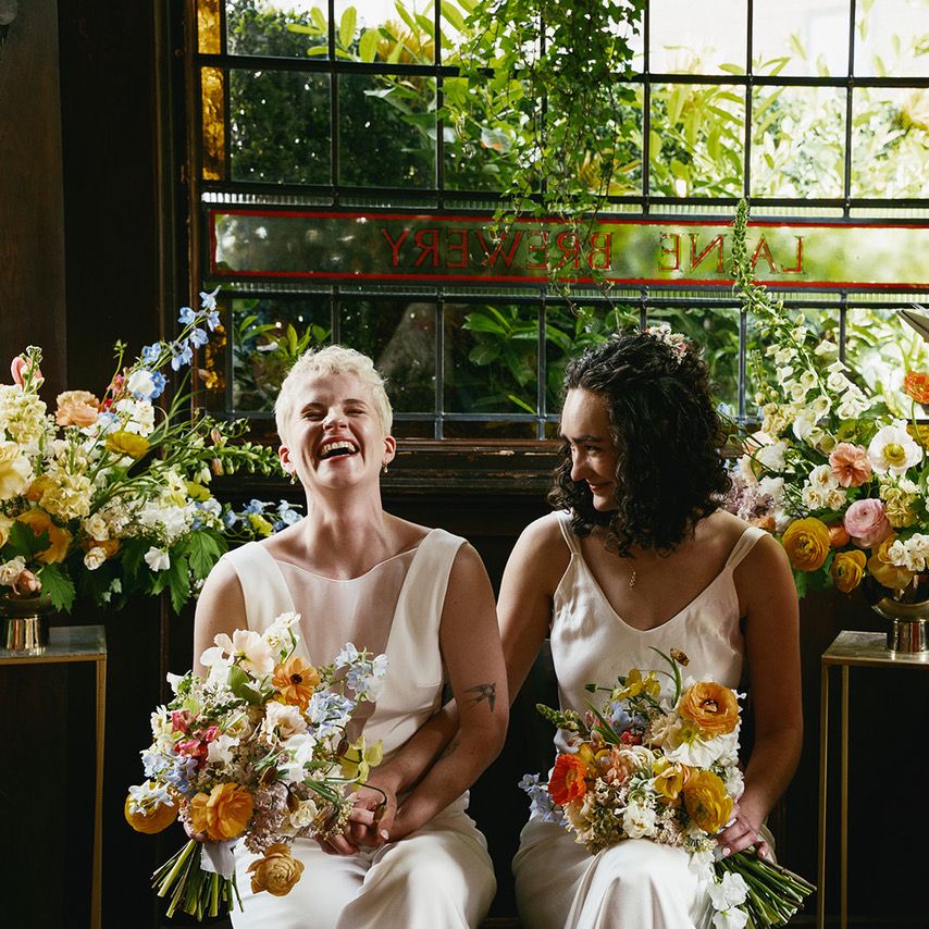 couple laughing as celebrant does ceremony reading