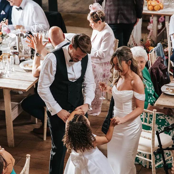 Bride & Groom Dancing with Flower Girl in White Bow Flower Girl Dress