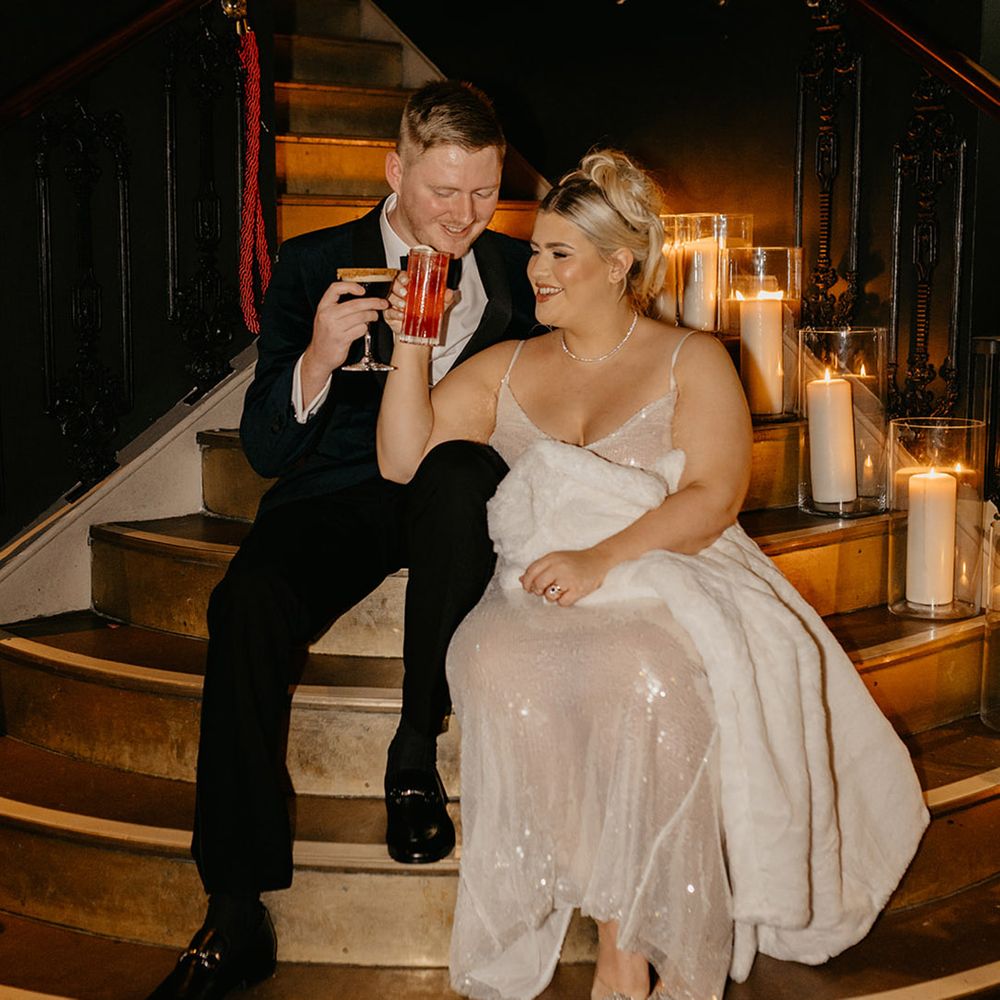 Bride and groom drinking wedding cocktails at their reception