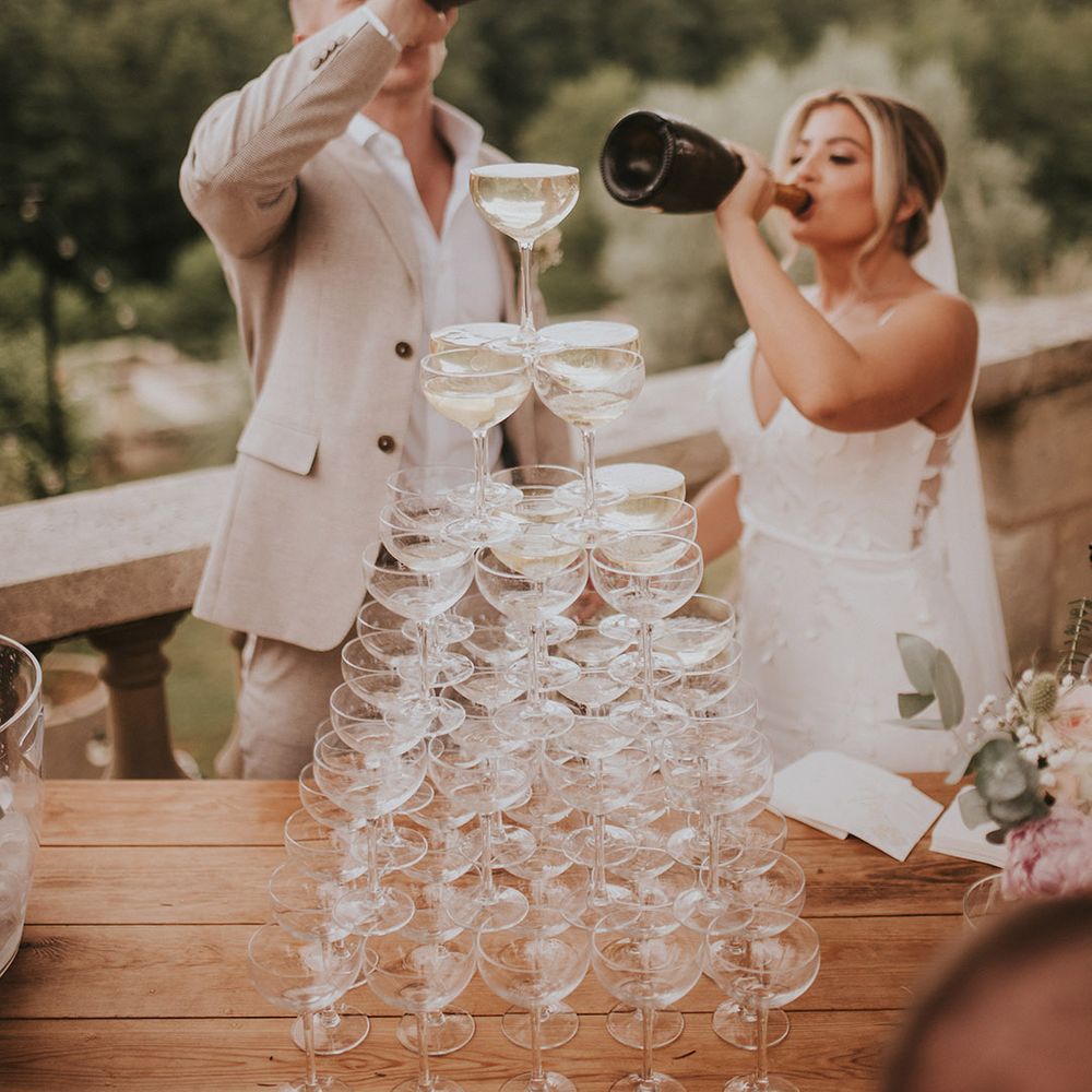 champagne-tower-with-bride-and-groom-drinking-champagne-from-bottle