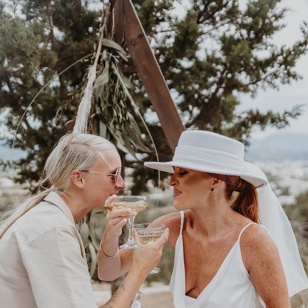 two-brides-drink-wedding-cocktails-at-same-sex-ibiza-wedding