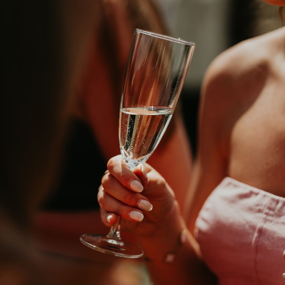 wedding-guest-drinking-glass-of-champagne