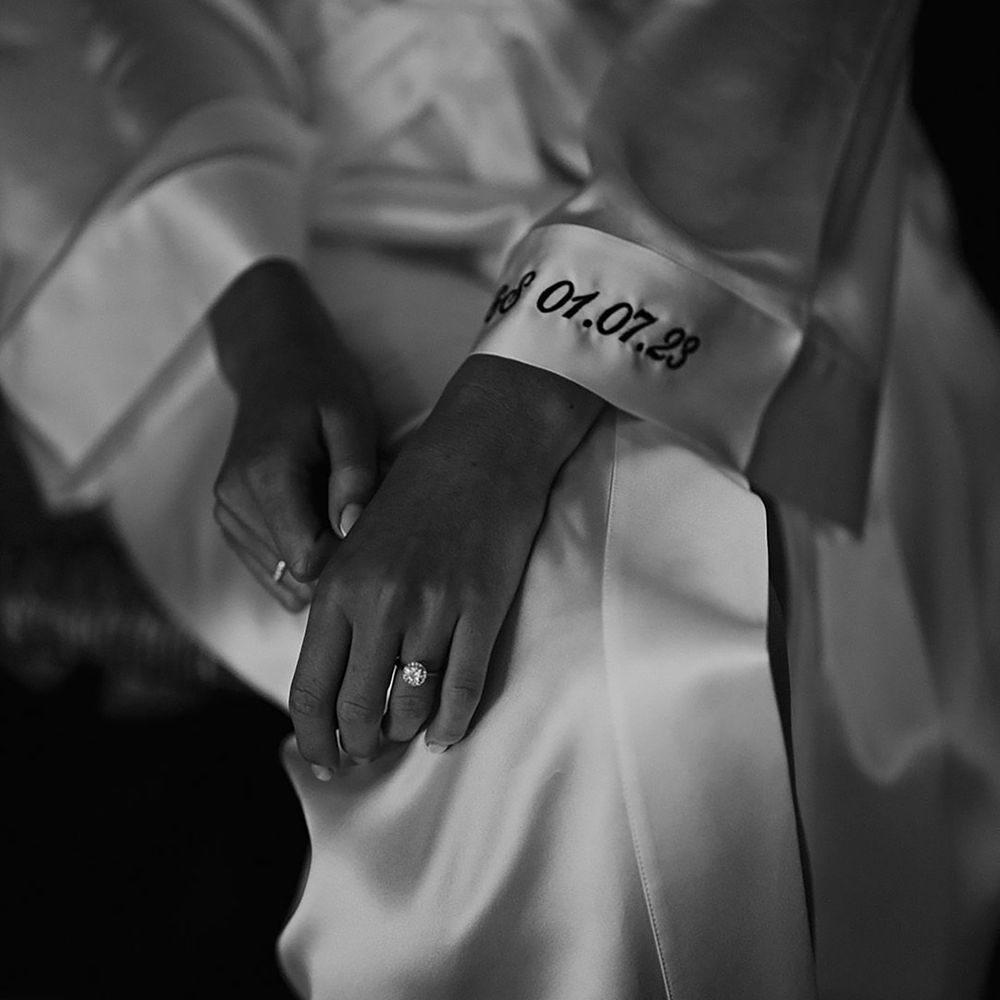 Embroidered wedding date on the cuff of the brides satin robe