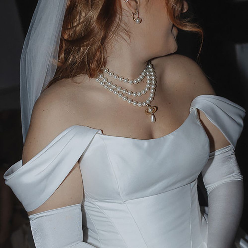 bride wearing a layered pearl wedding necklace