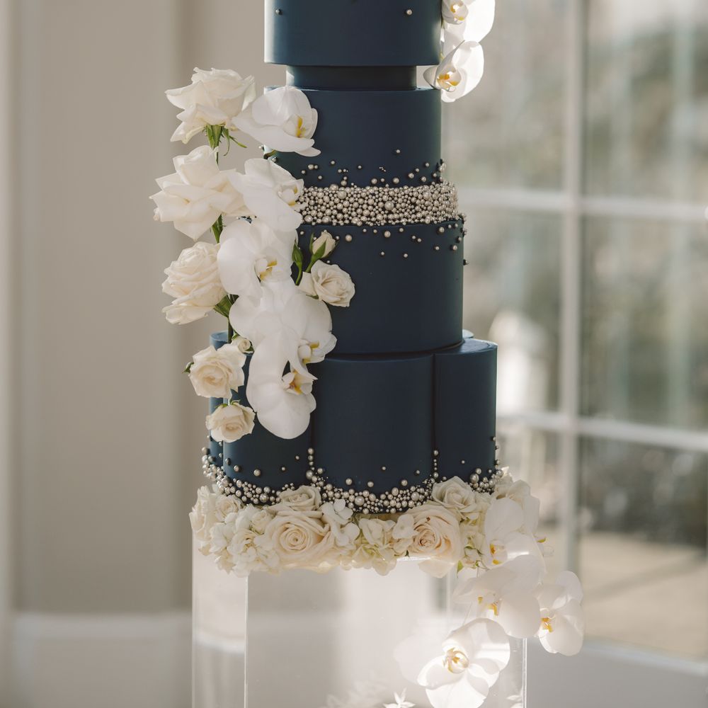 Winter dark navy blue iced wedding cake with pearls
