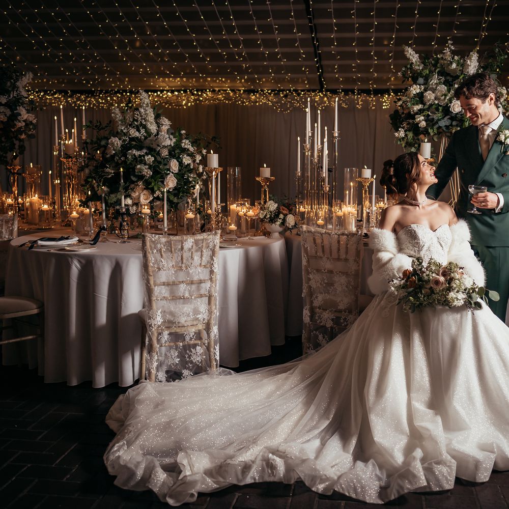 Bride and groom at winter wedding with enchanting tablescape
