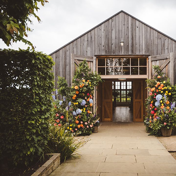 Colourful flower columns decorating entrance to wedding