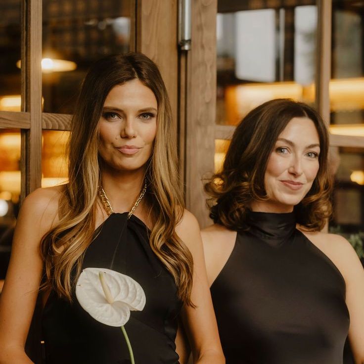 Bridesmaids in Black Satin Dresses Holding Single Stem Flowers Alternative To Bridesmaid Bouquets