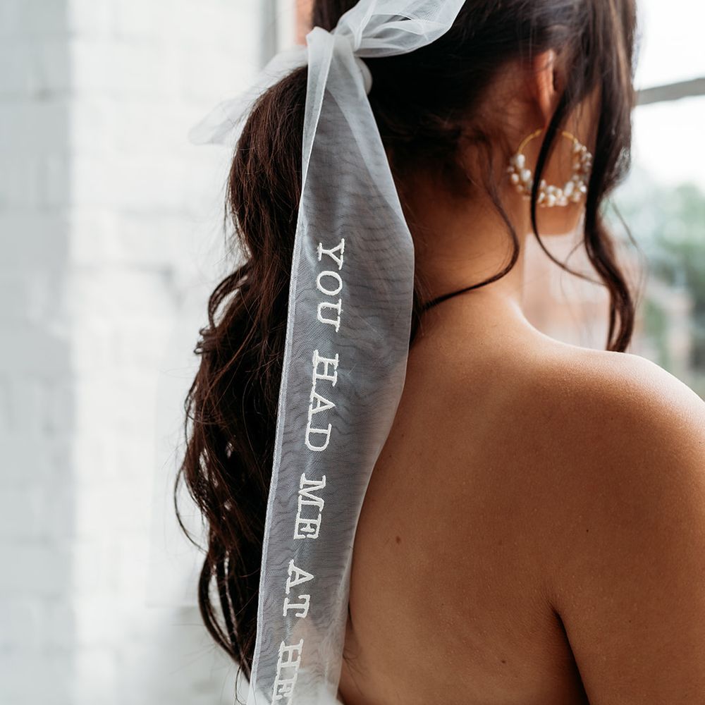 Bride wearing personalised white bow 