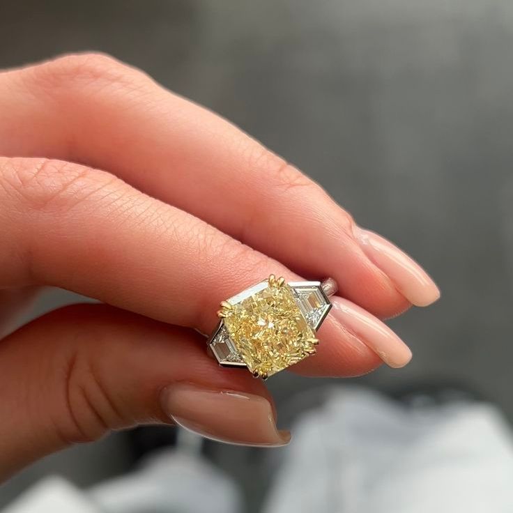 Three Stone Ring with Fancy Yellow Diamond and Trapezoid Side Stones