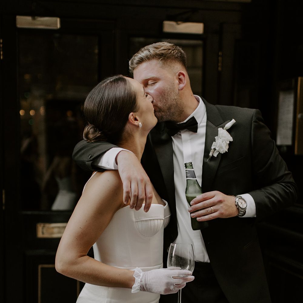 Bride wearing delicate short white bridal gloves 