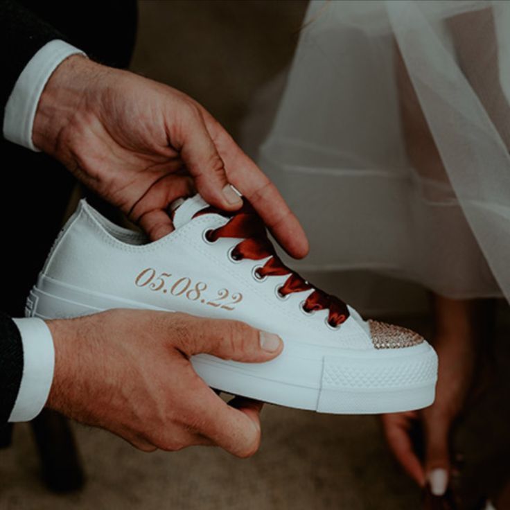Customised white trainers with the wedding date 
