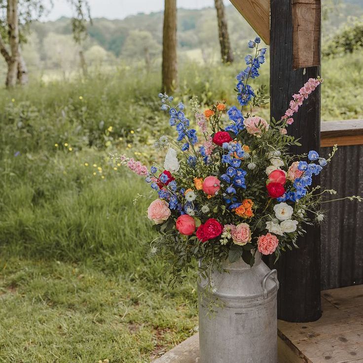 Dark Blue, Pink & Red Wedding Flowers in Milk Churn For Outdoor Wedding