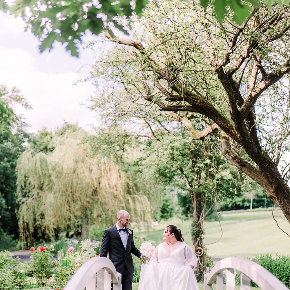Bride and groom on small bridge on wedding day