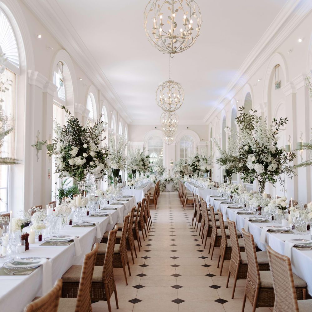 The Orangery wedding breakfast space with classic white flowers