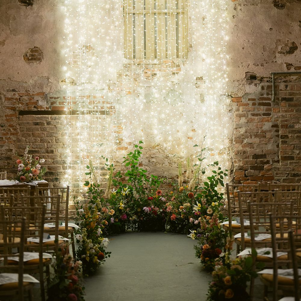 Rustic barn wedding ceremony with fairy lights