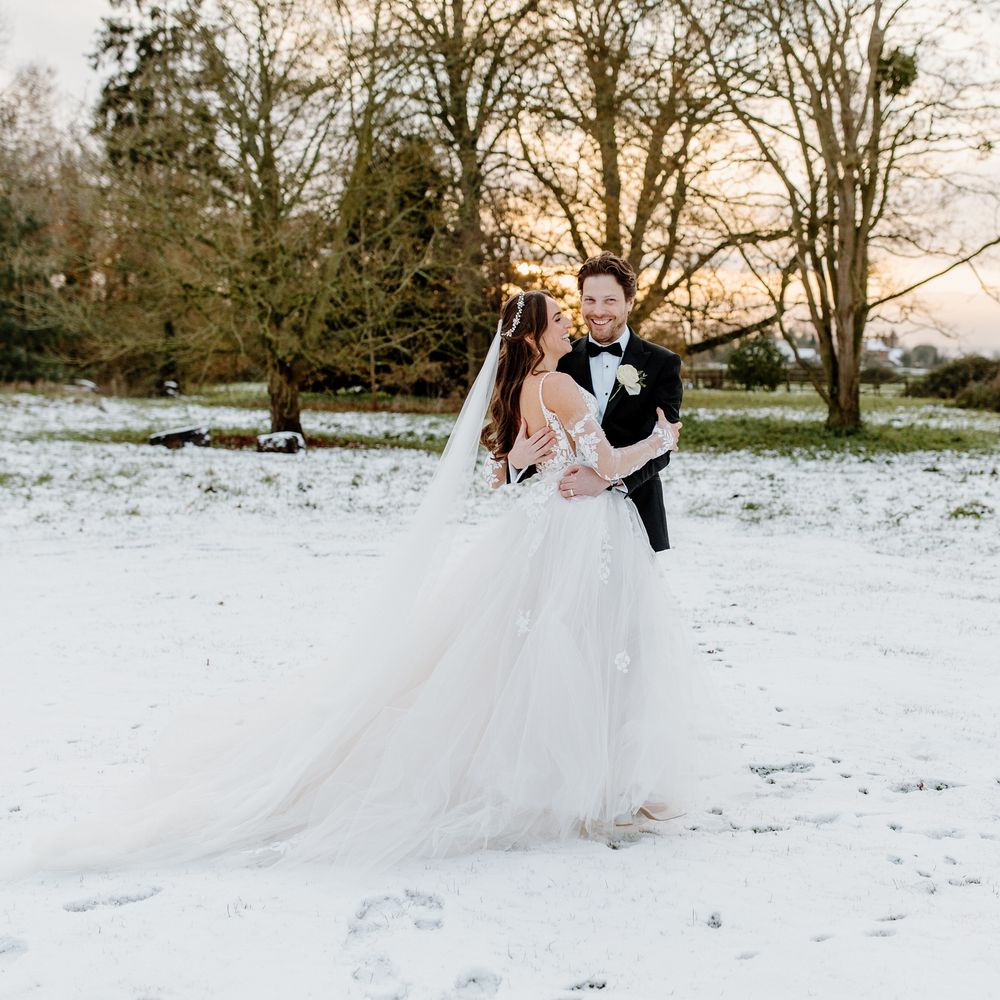 Snowy couple portraits at winter wedding   