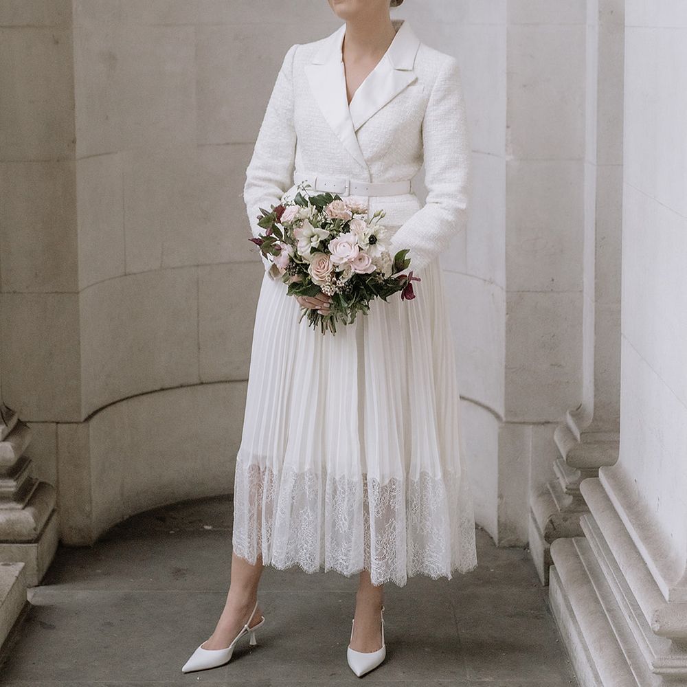 Bride at town hall wedding with small white bouquet