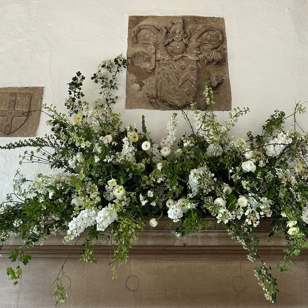 White wedding floral arrangement for fireplace