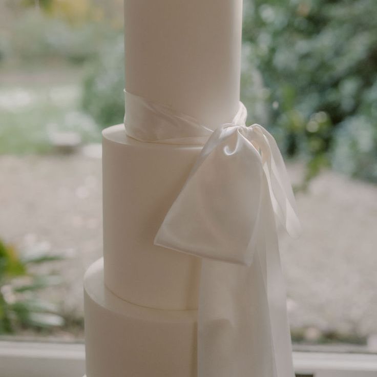 Classic & Traditional White Iced Wedding Cake Decorated with White Satin Bow