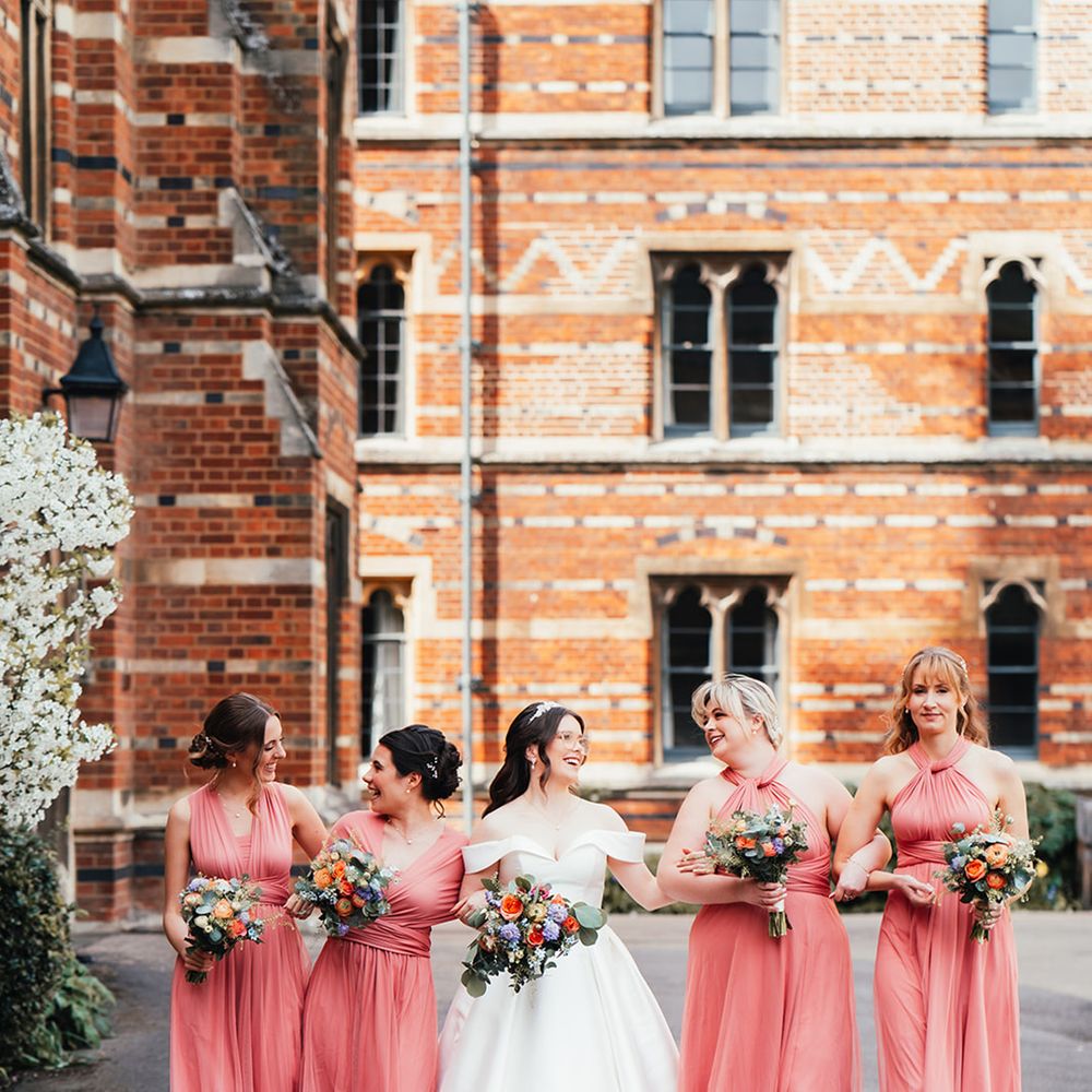 bridal-party-wearing-coral-bridesmaid-dresses