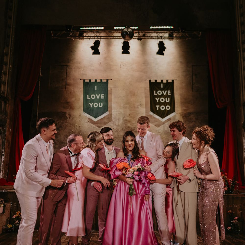 bridal-party-wearing-outfits-in-different-shades-of-pink