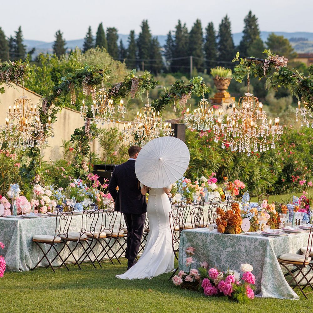 bride-carrying-white-umbrella-walking-around-venue