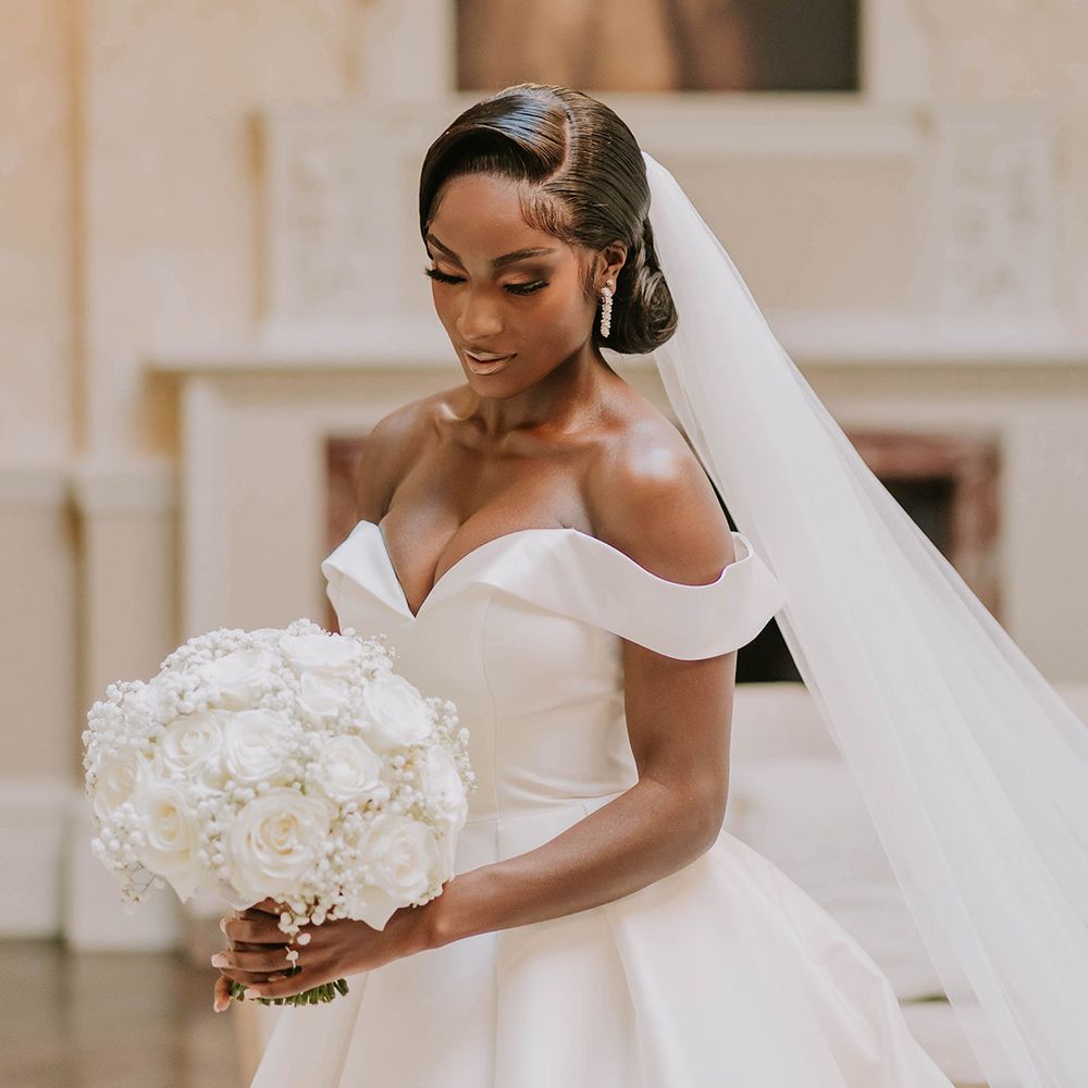bride-in-off-the-shoulder-wedding-dress-holding-white-rose-and-gypsophila