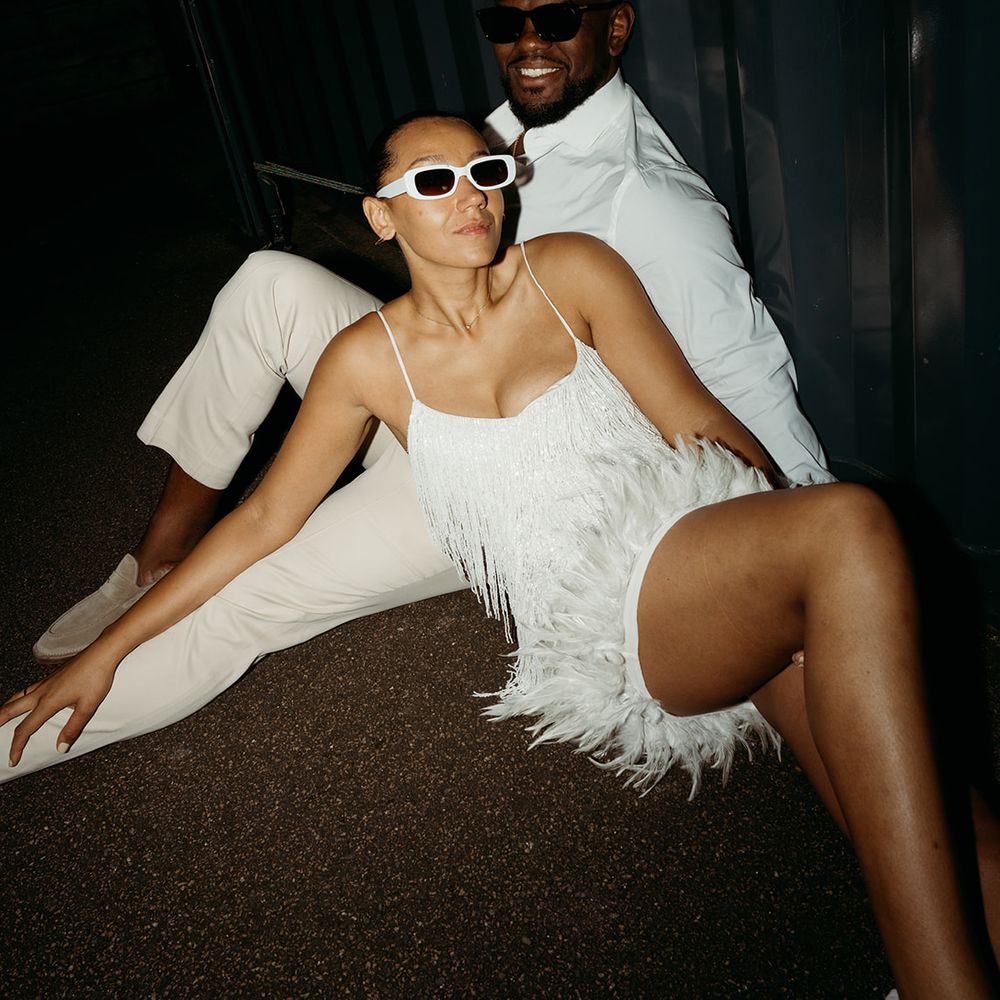 bride-in-short-white-tassel-dress-and-sunglasses-with-groom-in-white-shirt