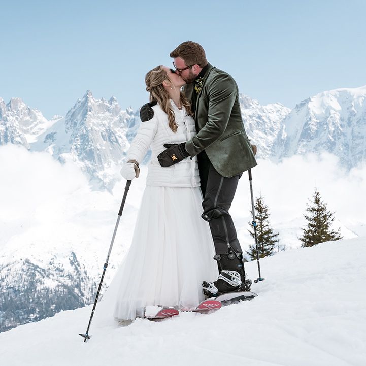 couple-kisses-on-mountain-in-french-alps