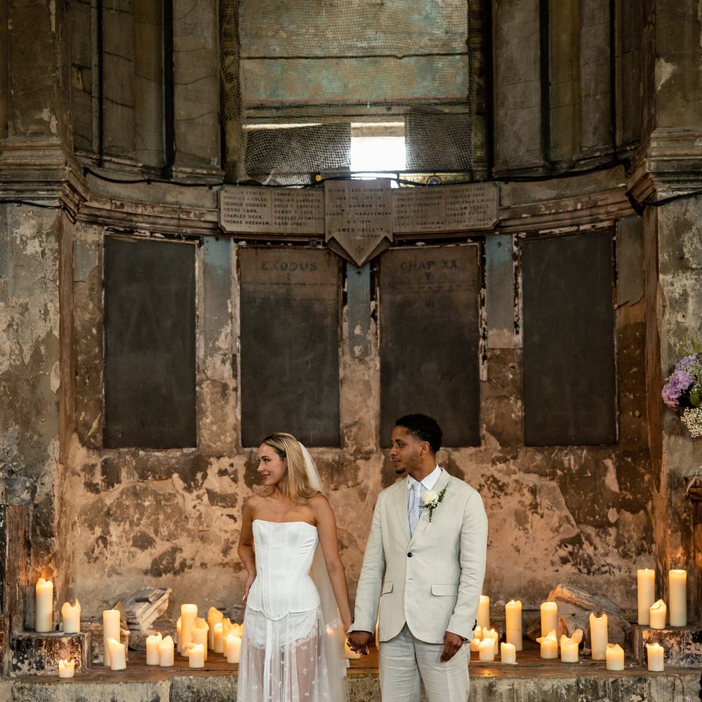 Bride in vintage lingerie inspired two piece at gothic wedding venue