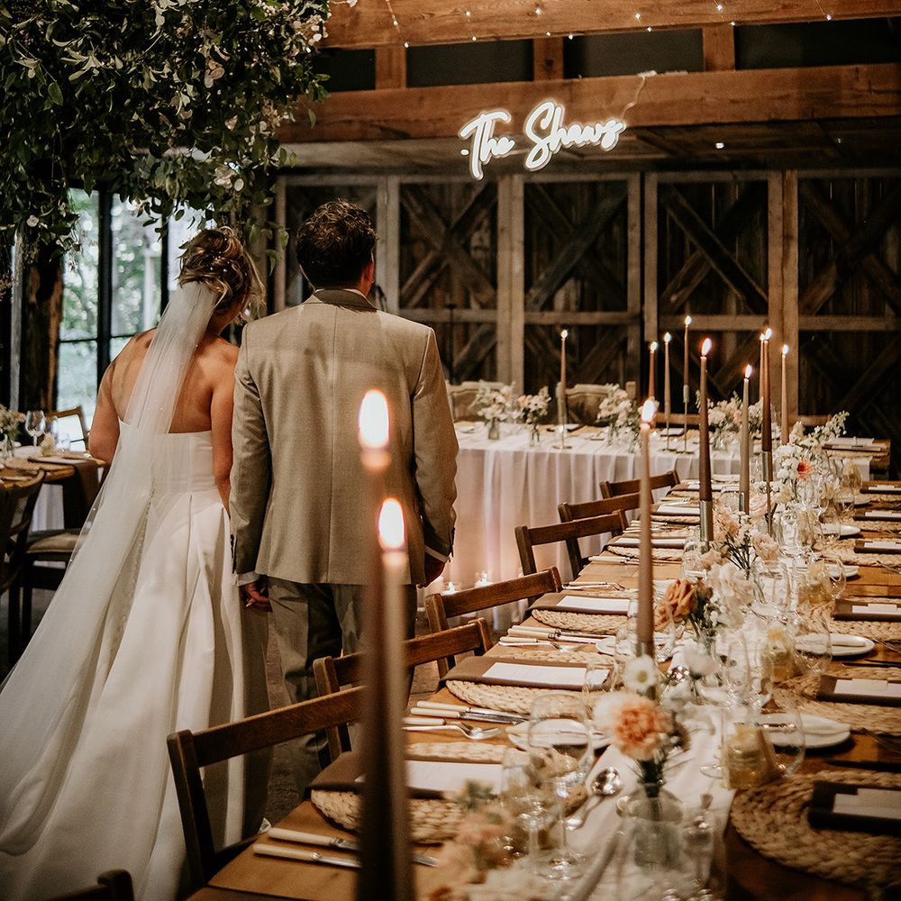 Rustic wedding at Dewsall Court with neon signage 