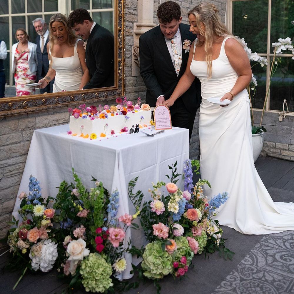 Couple cuts their modern rectangle wedding cake 