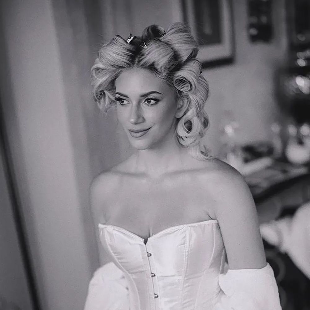 Bride getting ready wearing white lingerie corset