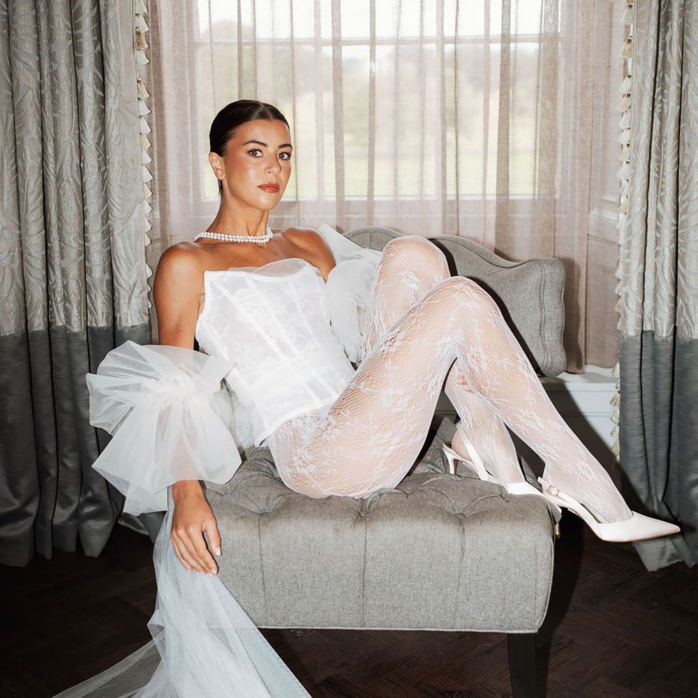 Bride wears white corset with white lace hoisery