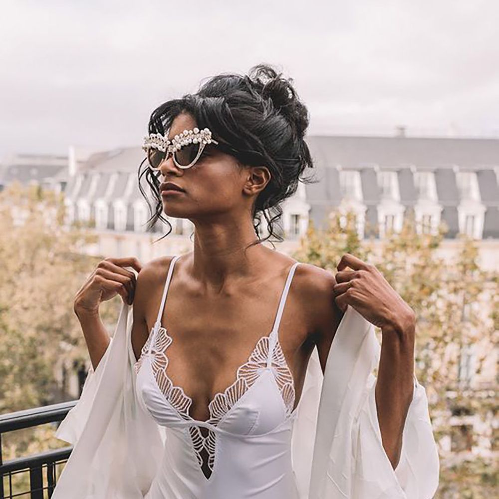 Bride wearing bridal lingerie bodysuit and robe on Paris balcony
