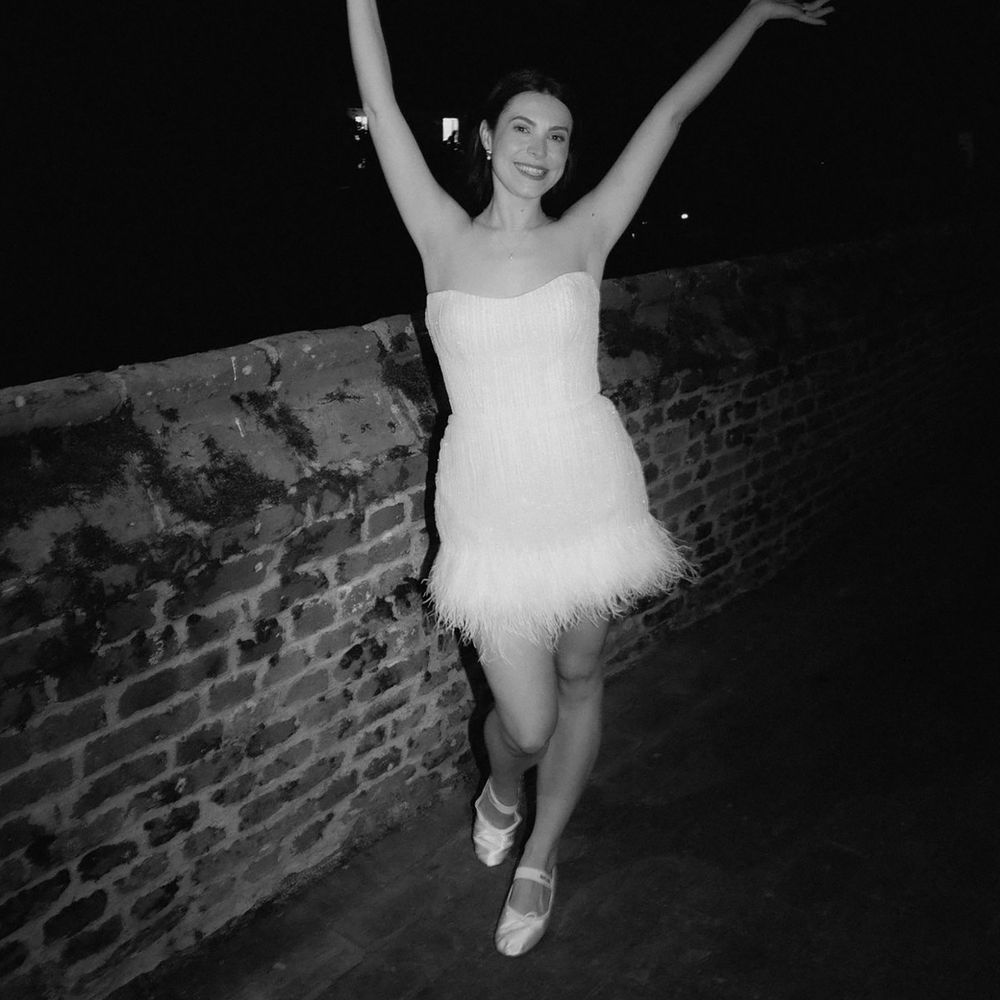 Bride in party bridal dress with strapless neckline with feathers