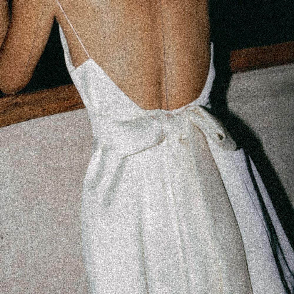 Bride wearing short hen do dress with bow back