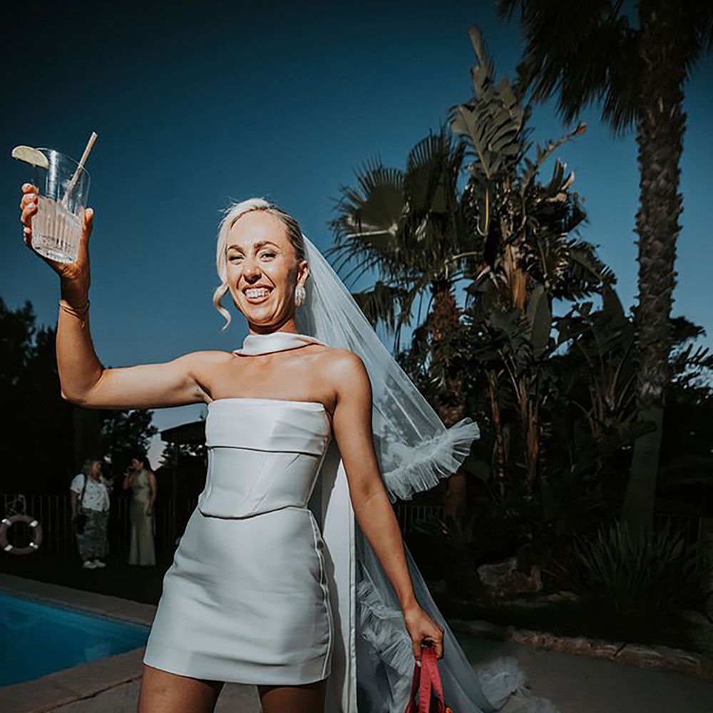 Bride in short reception dress with leopard print boots