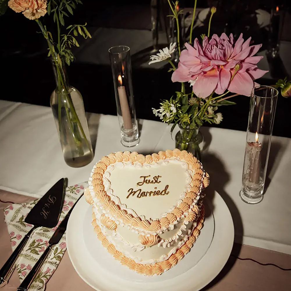 Heart shaped wedding cake and floral table decor